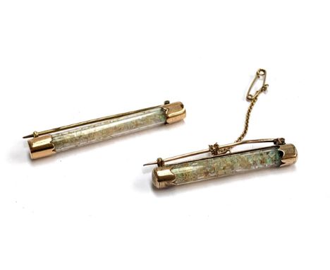 Two late Victorian gold mounted glass tube brooches containing Australian opal chips, 5.2 and 4.4cm long, one with safety cha