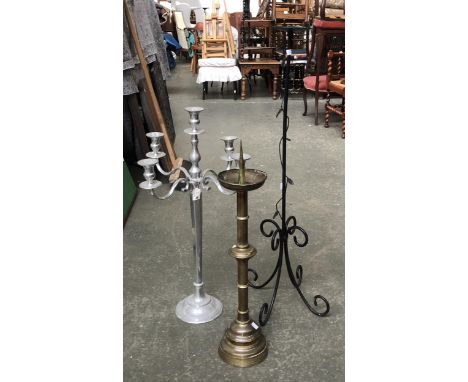A large white metal five fitting candlestick, 78cmH; together with a pricket candlestick, 72cmH; and one other wrought iron c
