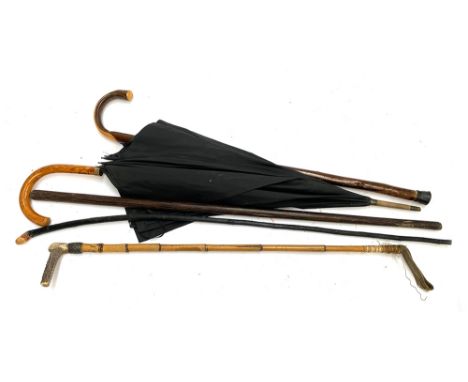 A vintage umbrella; walking cane; bamboo and antler handled riding whip etc