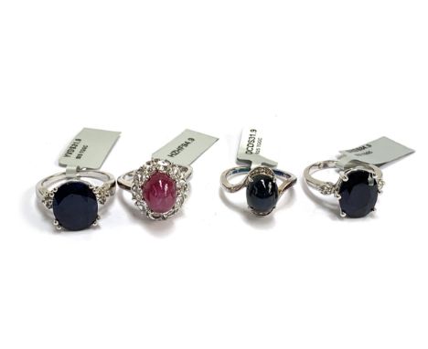 Four silver rings: one set with a star sapphire and white topaz; one star ruby, 6.2cts, and white topaz; Madagascan sapphire 