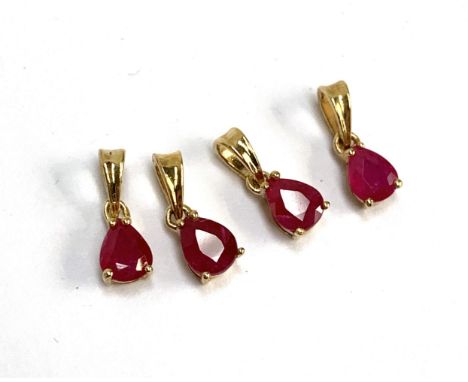Four small 9ct gold mounted ruby charm pendants, the Burmese rubies each 0.4cts and measuring 5x4mm, gross weight 1.1g