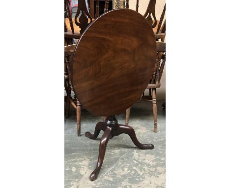 A George III mahogany tilt-top tripod table, the one piece circular top on a wrythen turned column, on tripod cabriole legs a