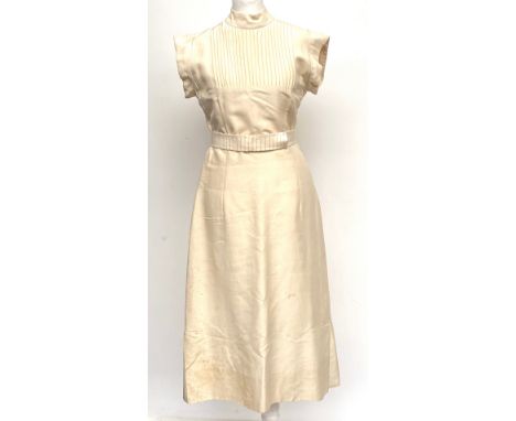 A vintage 1940s style beige silk short sleeved dress with pleated bib detail and matching belt, approx. size 8Provenance: fro
