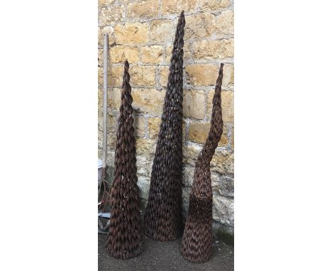 Three conical wrought metal spiral garden ornaments, the tallest 176cm