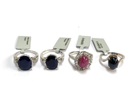 Four silver rings: one set with a star sapphire and white topaz; one star ruby, 6.2cts, and white topaz; Madagascan sapphire 