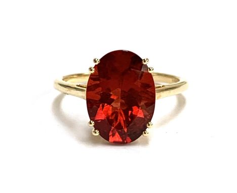 A 14ct gold and red andesine ring, the Tarocco red andesine 4.3cts and 14x10mm, size S, 3.6g