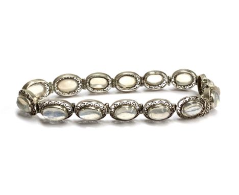 A vintage silver bracelet set with moonstones in pierced floral panels, with safety chain, 14.9g