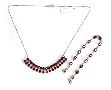 A sterling silver and ruby fringe necklace, the madagascan rubies totalling 22.8cts; together with a silver and ruby tennis b