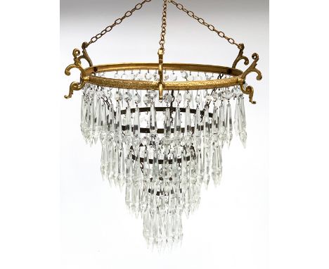 A four tier gilt metal chandelier with cut glass drops, the upper ring 29cmD