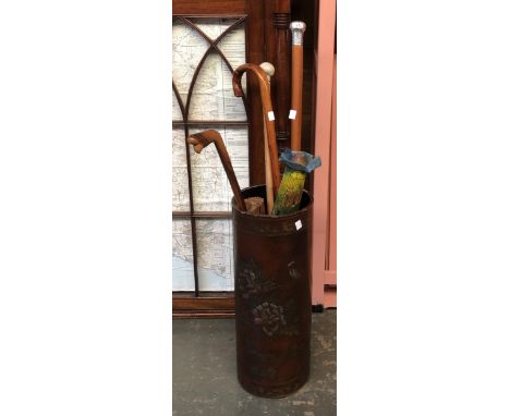 A Chinese lacquered stick stand containing a number of walking sticks, to include malacca walking cane with hallmarked silver