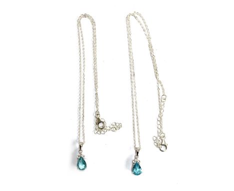 Two silver mounted Madagascan blue apetite and white topaz pendants, each measuring 1.8ct, on silver chains, 8.4g gross weigh