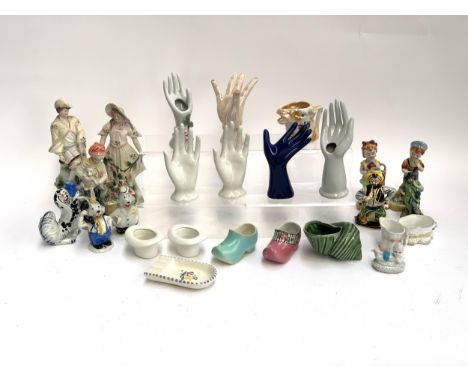 A quantity of ceramics to include porcelain hands; Capodimonte figures; Poole pottery; Wilkinson ceramic clogs etc