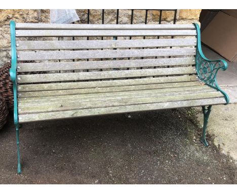 A green painted wrought metal garden bench with wooden slats, 125.5cmW