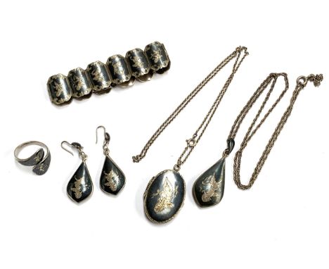 A quantity of Thai niello silver jewellery comprising panel bracelet, locket, earrings, crossover ring and pendant, gross wei