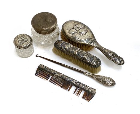 A chased silver dressing table set by William Comyns &amp; Sons London 1900, comprising hair brush, clothes brush, and comb; 