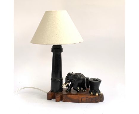A carved hardwood and ebony table lamp with elephant, 41cmH including shade