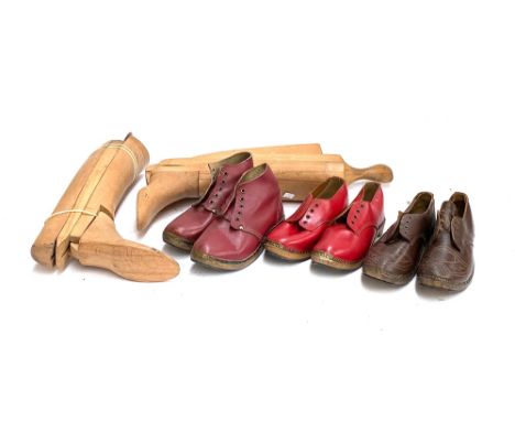 A pair of beechwood boot trees; together with three pairs of vintage clogs