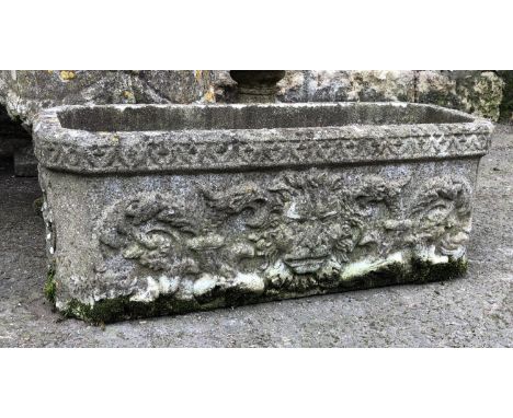 A rectangular composite stone trough planter with lion mask detail, 70x27x26cmH