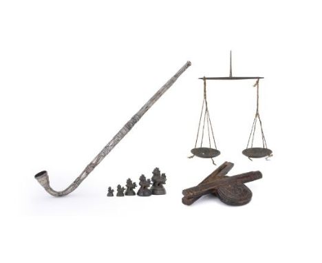A set of Burmese bronze toe myin 'opium' weights; an opium scale with wood case and a Burmese silver opium pipe the wood figu