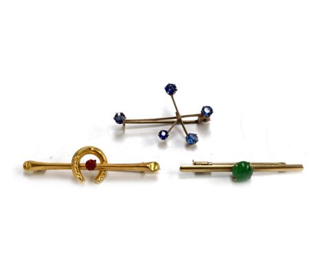 A 14t gold bar brooch set with a jade cabochon, the jade approx. 7mmD, the brooch 4cmL, 1.5g; a 9ct gold and blue paste South