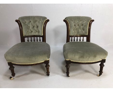 Pair of low button back, upholstered, wooden framed nursing chairs