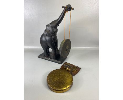 Oriental Carved wooden Elephant with out stretched trunk holding a gong, approximately 50cm high (tusks missing) along with a