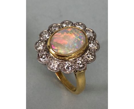 18ct Yellow Gold Opal &amp; Diamond cluster ring the Oval cut Opal set in a tellow gold rope design mount and surrounded with