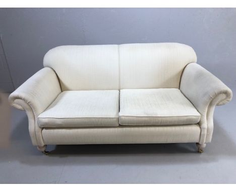 Modern two seater cream upholstered sofa 