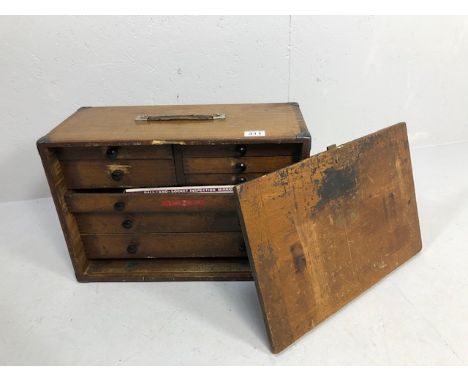 Wooden portable tool chest opening to reveal nine drawers and containing various engineering tools