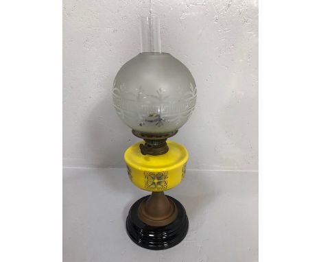 Antique 19th century brass oil lamp, modernist yellow reservoir with frosted glass shade on a black base approximately 53cm i