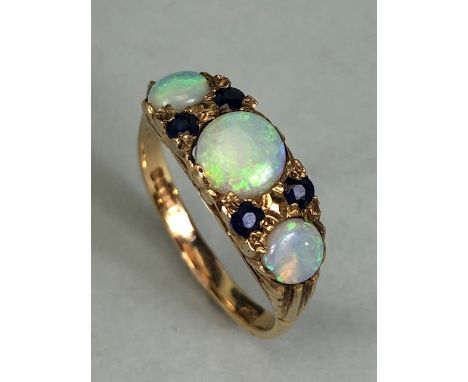 9ct Gold three stone Graduated Opal ring set the Opals separated by pairs of Blue Gemstones size approx 'K'