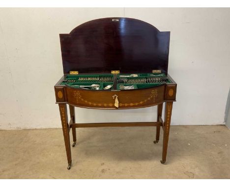 A twelve setting canteen of early 20th century silver plated cutlery contained within an Edwardian mahogany and inlaid bowfro