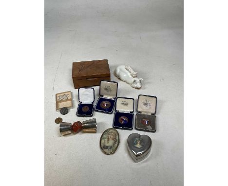 A small group of collectors' items including an oval portrait miniature on celluloid, heart shaped trinket box, cased medalli