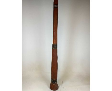 An Aboriginal didgeridoo with three bands of dot painted detail, height 147cm.