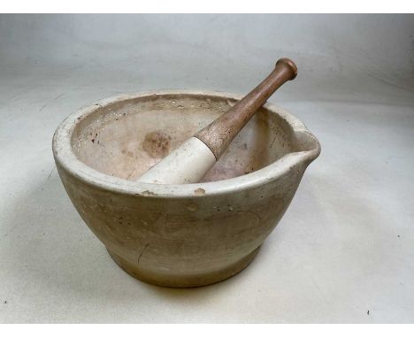 An early 20th century ceramic pestle and mortar, 'Made in England 11' impressed to the base, beech handle to the pestle, mort