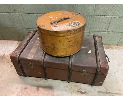 A large strap bound trunk and a plywood hat box (2) 