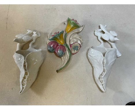 A Clarice Cliff floral spray wall pocket, height 25cm, and pair of Royal Worcester porcelain wall pockets, height 28cm.