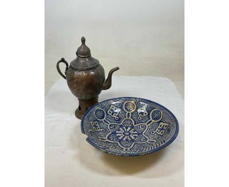 A Middle Eastern coffee dallah coffee pot and a Middle Eastern blue painted ceramic bowl.