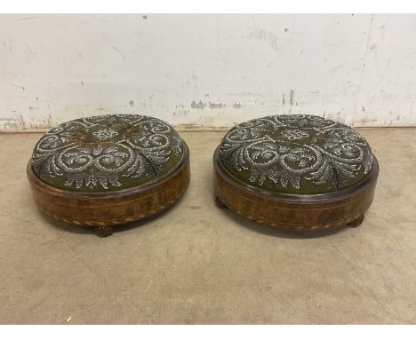 A pair of Victorian walnut inlaid bead decorated circular footstools, each raised on three treacle glazed ceramic feet, diame