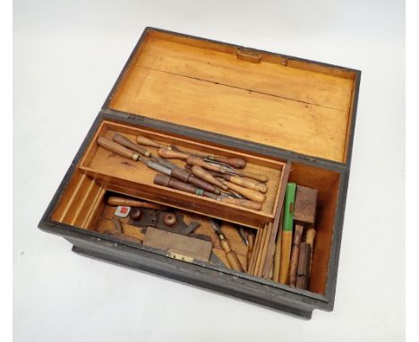 An antique carpenters chest with sliding trays and contents of woodworking tools including large selection of named chisels s