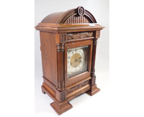 A Victorian walnut arch top architectural style mantel clock with pillar supports and silvered Art Nouveau spandrels, 48cm ta
