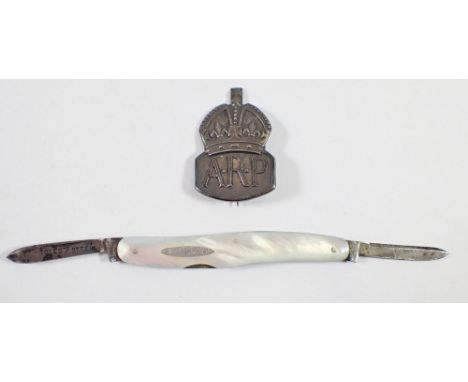 A silver and mother of pearl penknife and an ARP badge 