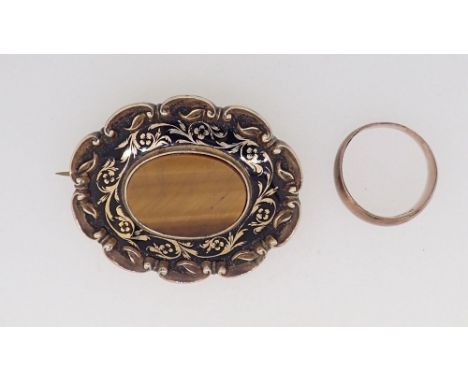 A Victorian gold oval brooch set tigers eye with enamel surround 15.5g total weight (unmarked but tested as 9ct gold) plus a 