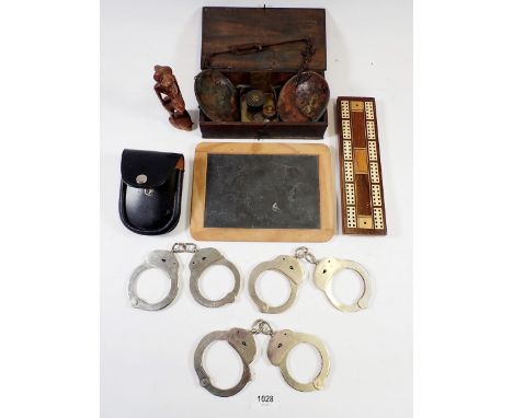 A box of collectables including cribbage board, handcuffs etc. 