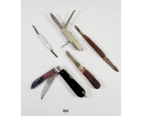 A group of five vintage penknives and belt holder 