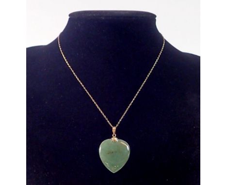 A 14k gold Chinese jade heart form pendant 3cm drop on 14k gold chain 46cm long 