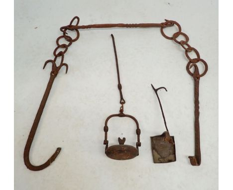 A 17th century wrought iron hanging oil wick lamp plus a French miners cast iron whale oil lamp and a set of iron fireplace p