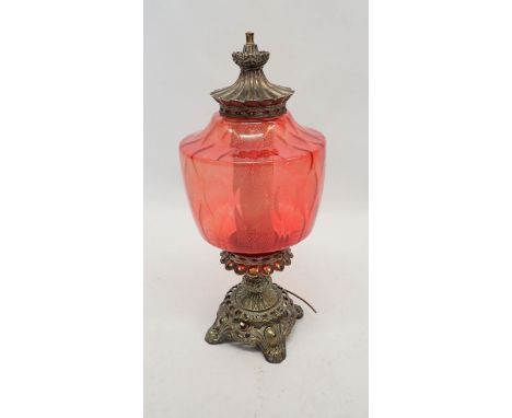 A Victorian brass oil lamp with large cranberry tinted glass shade, 64cm tall 