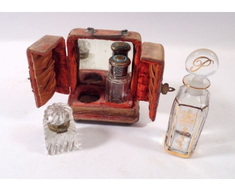 A 19th century glass smelling salts bottle with silver plated and turquoise bead lid in fitted stand plus gilt scent bottle a
