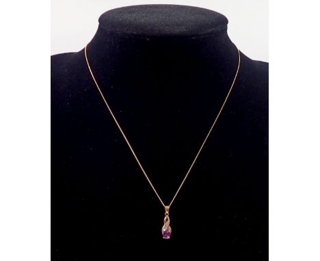 A 9 carat gold amethyst pendant, 1.5cm diameter and chain, 40cm long 